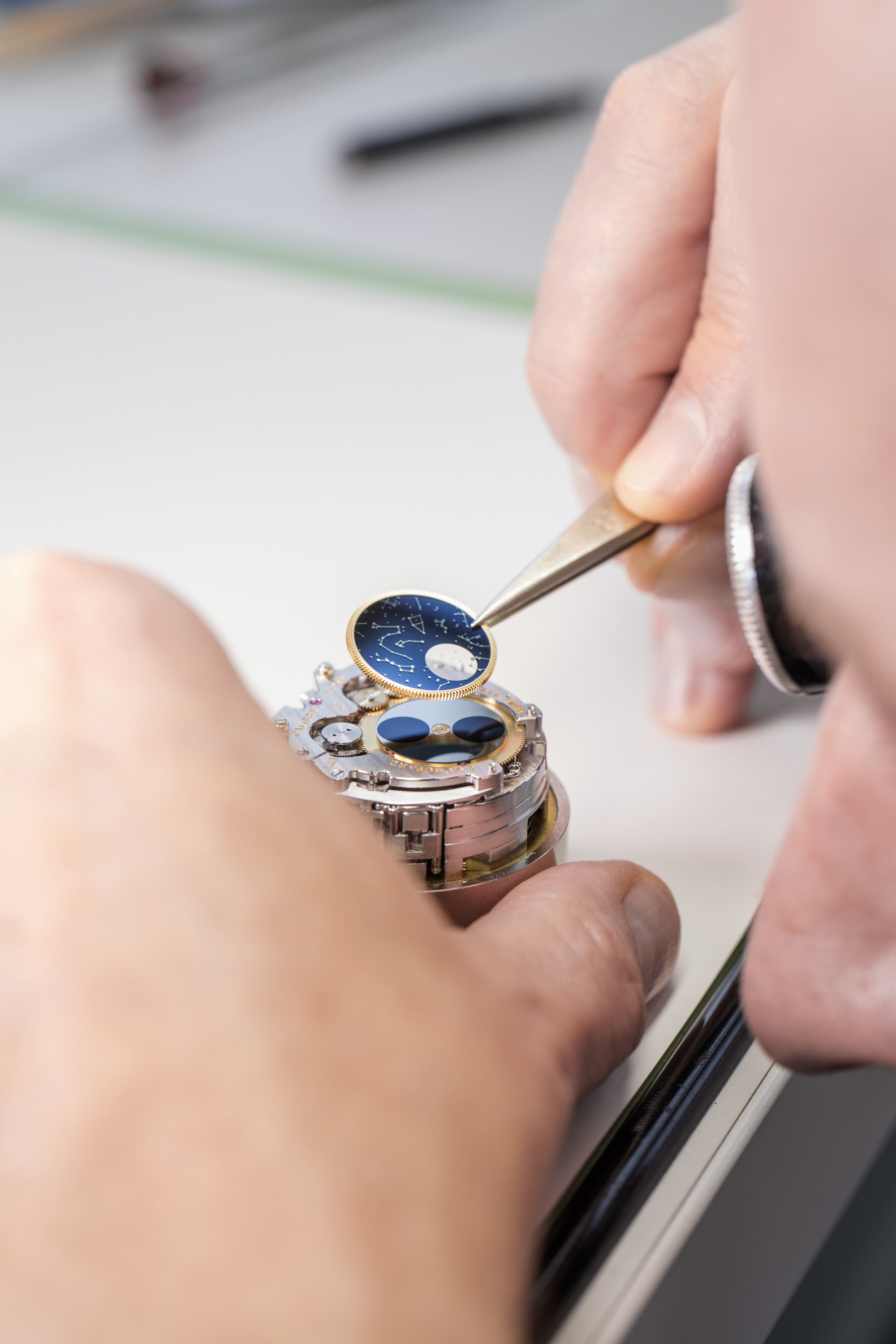 The master watchmaker at work on the set up of the moon phase superior disk