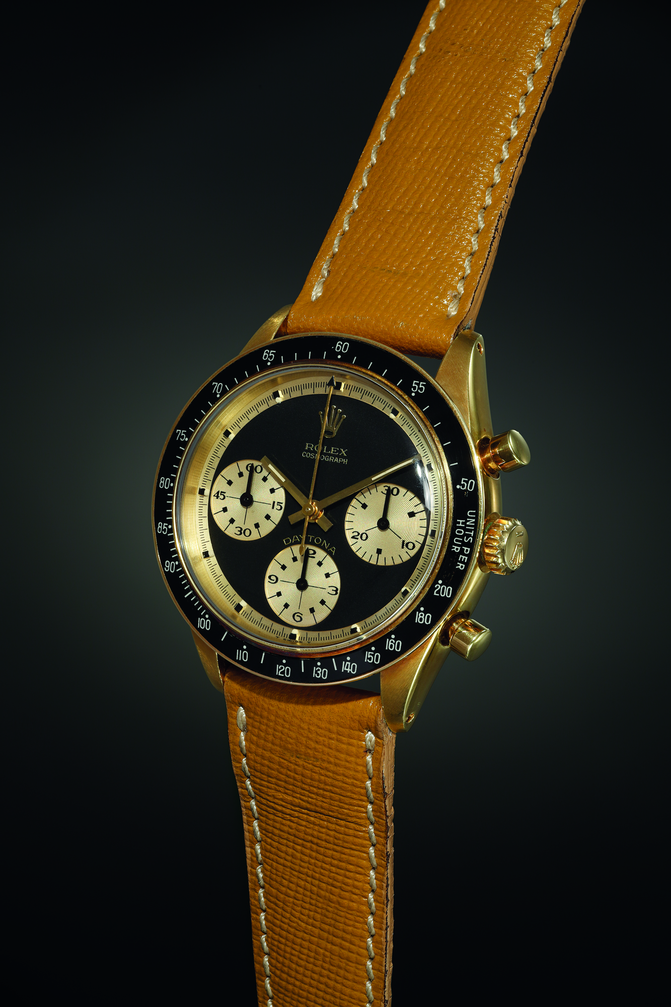 An exceedingly rare and outstandingly beautiful yellow gold chronograph wristwatch with black ‘Paul Newman’ dial displaying contrasting gold registers. Realised CHF 912,500