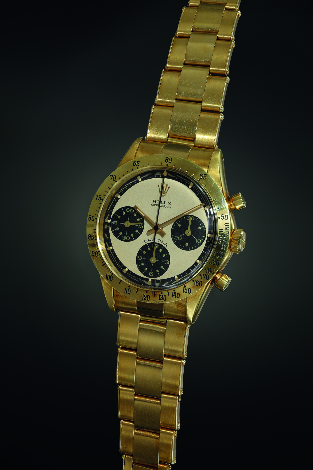 A very rare and extremely well-preserved yellow gold chronograph wristwatch with champagne ‘Paul Newman’ dial, factory sticker, tachymeter bezel and bracelet. Realised CHF 948,500