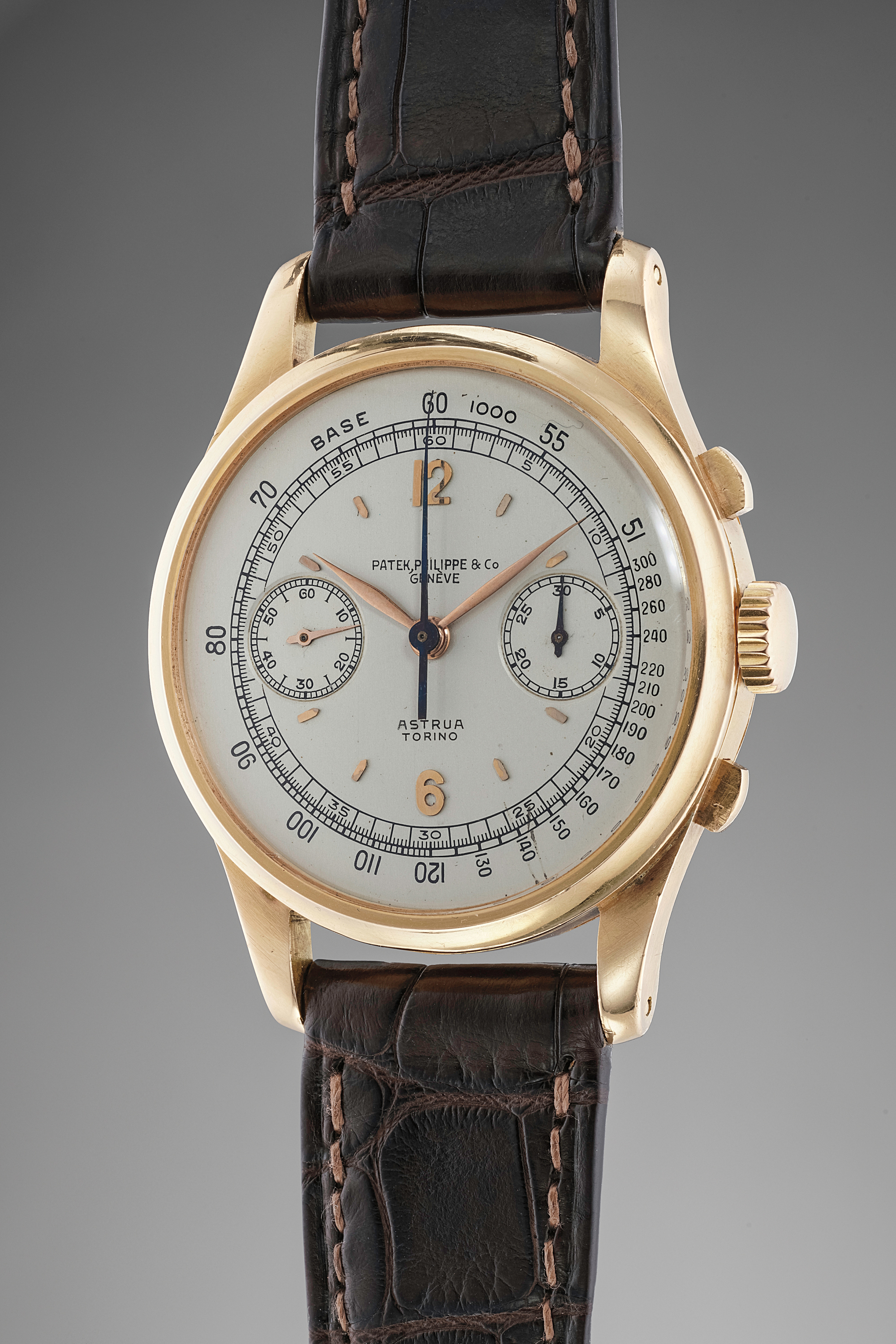 An extremely rare, large and very attractive pink gold chronograph wristwatch off-white dial retailed by Astrua Torino.
