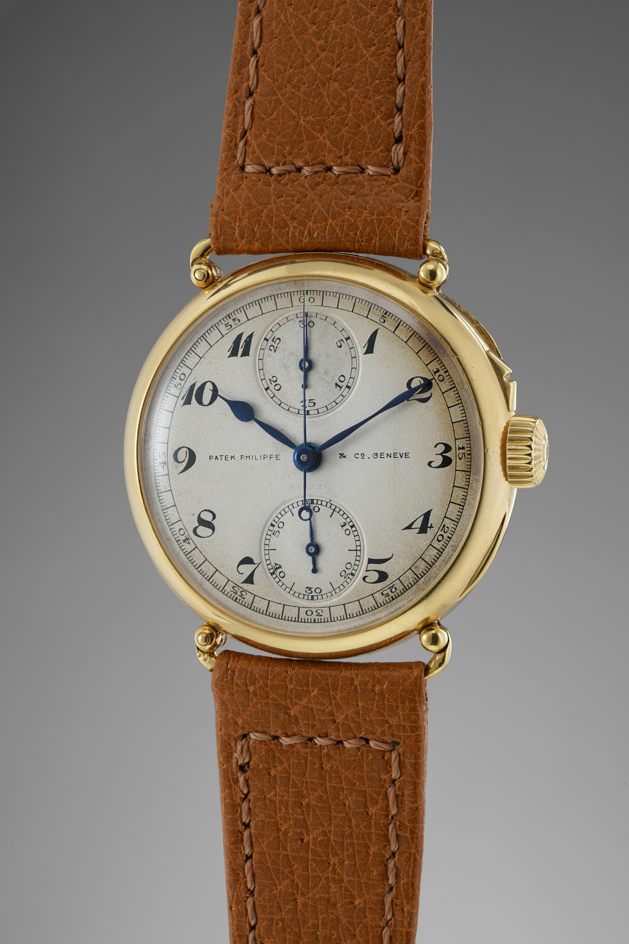 An extremely rare, well preserved and historically important yellow gold single pusher chronograph wristwatch with vertical registers and officer case.