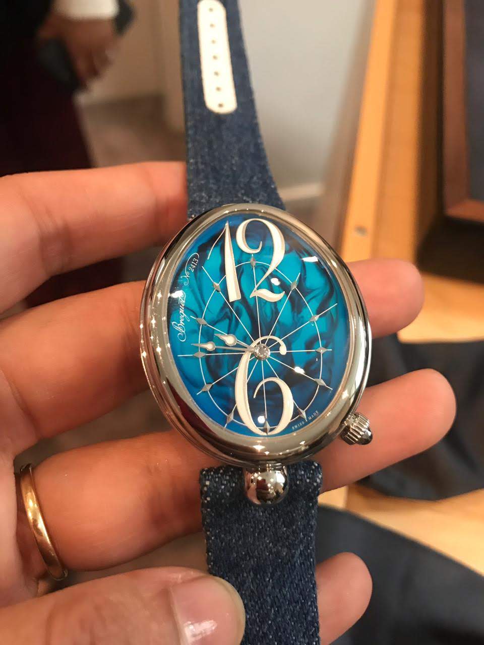 Two new pieces join the Reine de Naples family. This one comes in a deep-blue lacquer with turquoise blue scrolls. This unique dial was achieved by placing a touch of clear lacquer on still liquid dark material and then combined. The colours mix automatically to form a new design each time. 